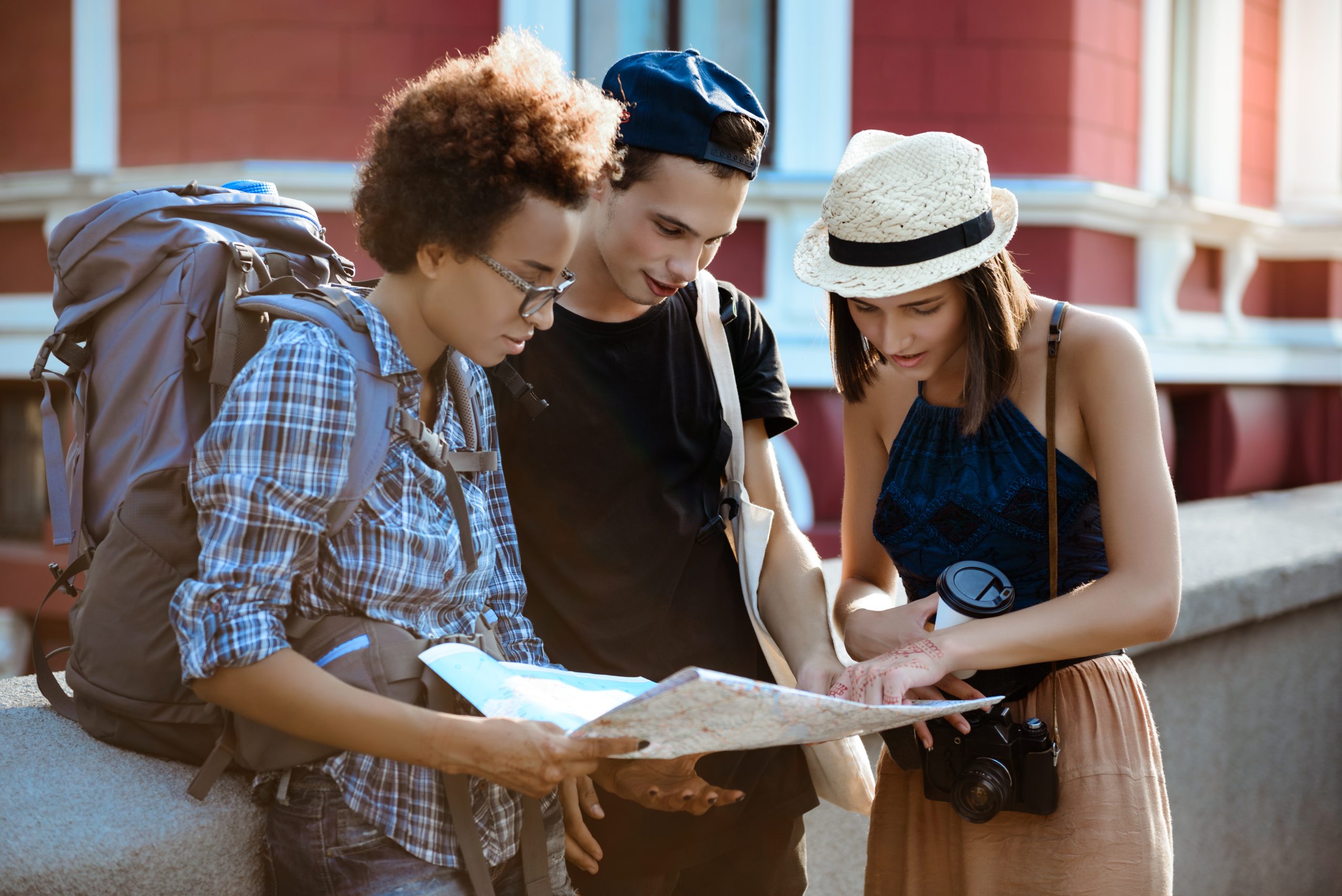 Facilities 15 friends travelers with backpacks smiling looking route map street scaled 1