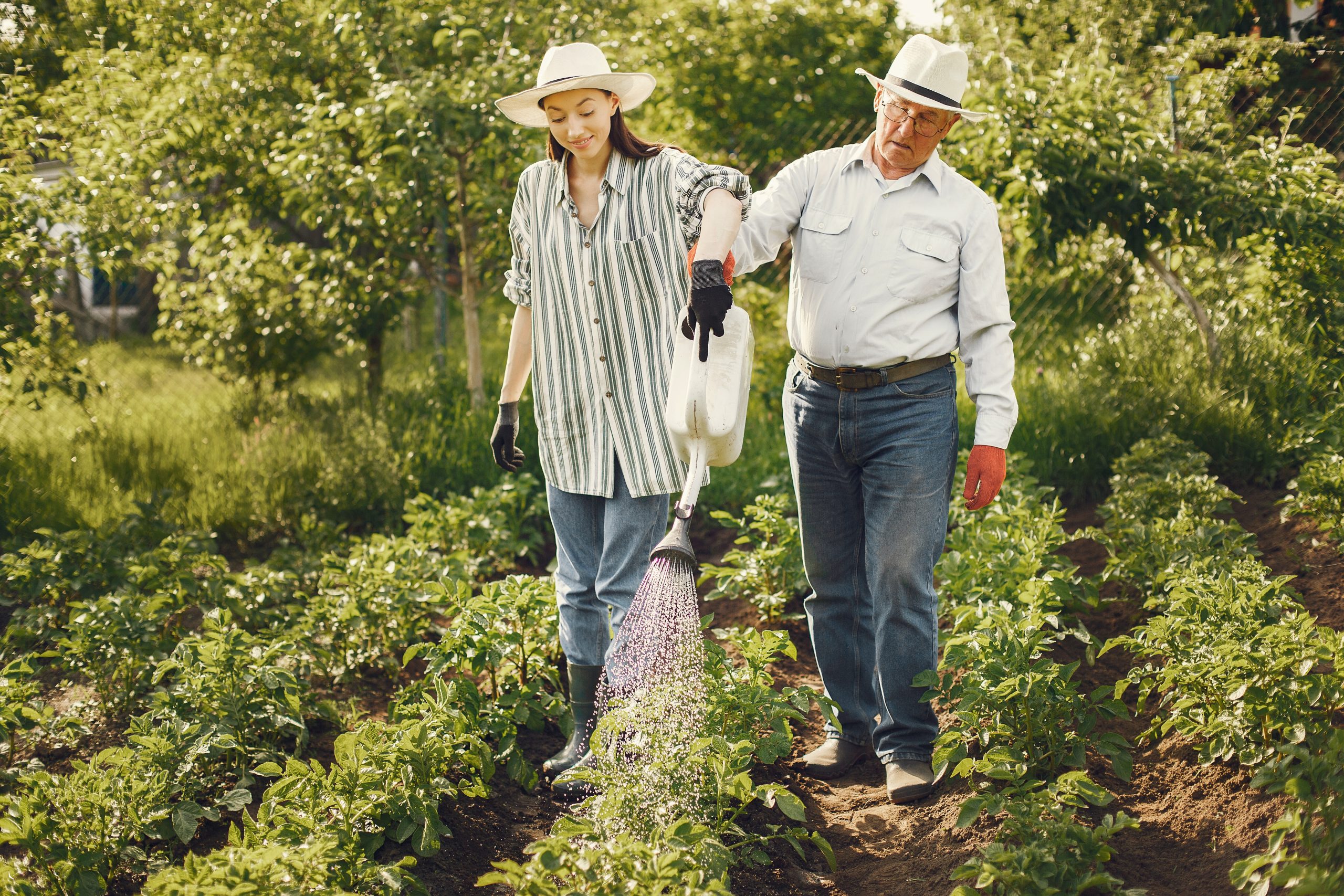 Facilities 14 portrait senior man hat gardening with granddaugher scaled 1